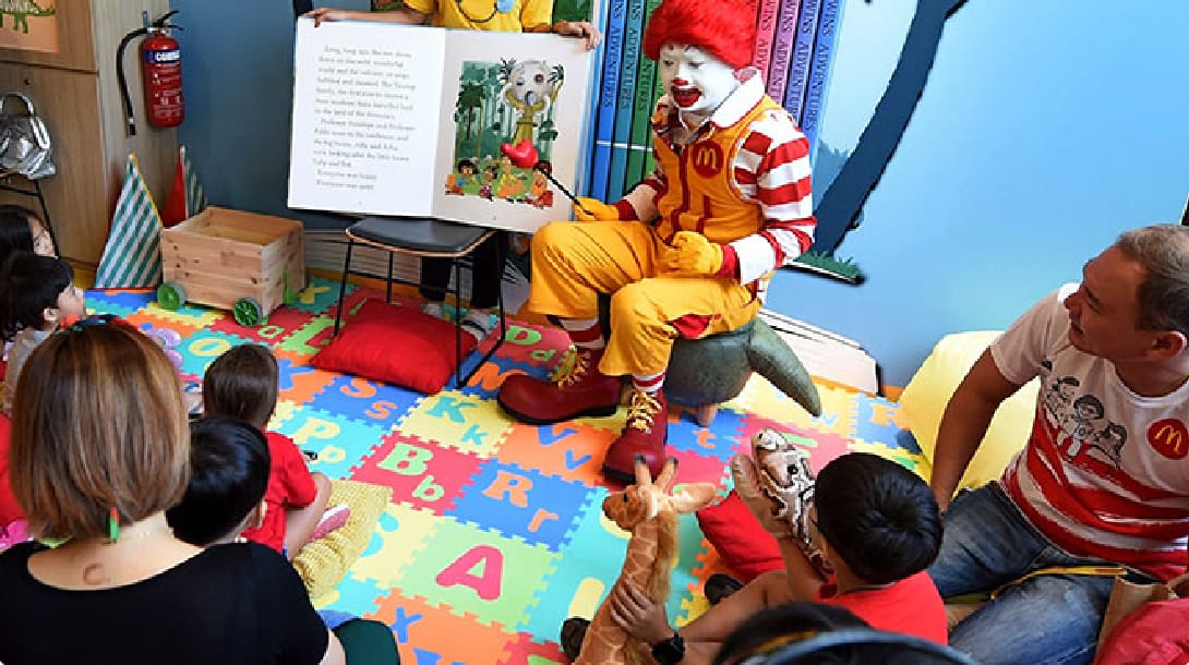 Ronald McDonald and a Family Ambassador conducting a storytelling session
